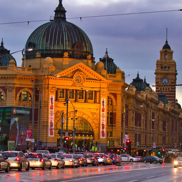 The finished puzzle: a grand Victorian building at dusk, its dome and clock tower lit gold